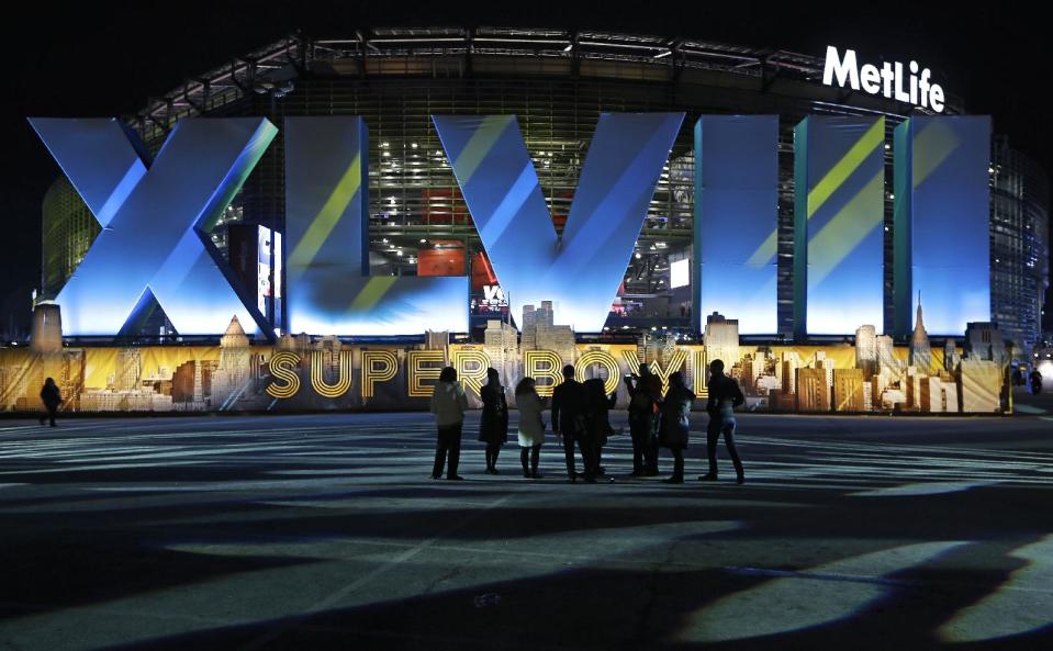 Fans walk near MetLife Stadium before the NFL Super Bowl XLVIII football game between the Seattle Seahawks and the Denver Broncos Sunday, Feb. 2, 2014, in East Rutherford, N.J. (AP Photo/Seth Wenig)