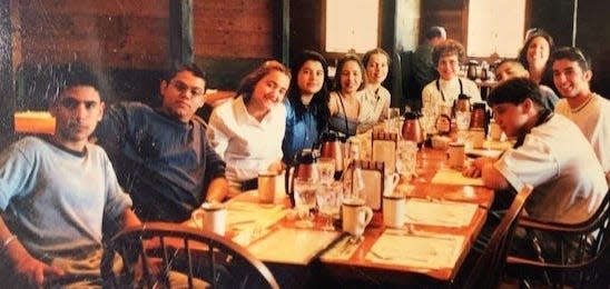 Peg Fasino, center at end of table, with her students in English as a Second Language at a Weymouth restaurant in the 1990s.