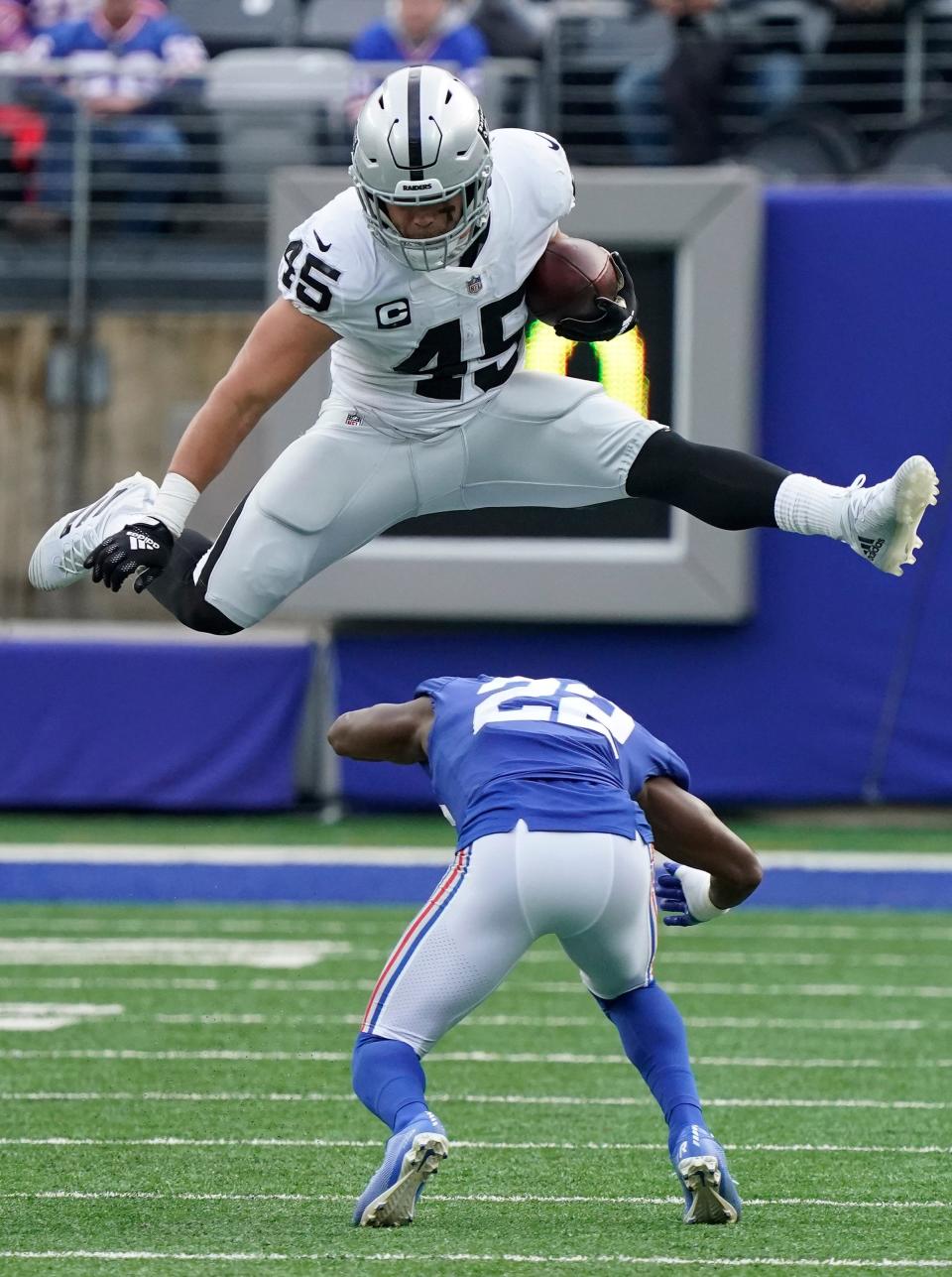 Fullback Alec Ingold, then with the Raiders, hurdles Giants cornerback Adoree' Jackson.