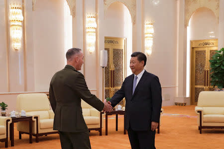 U.S. Chairman of the Joint Chiefs of Staff Gen. Joseph Dunford shakes hands with President Xi Jinping at the Great Hall of the People in Beijing, China August 17, 2017. REUTERS/Andy Wong/Pool