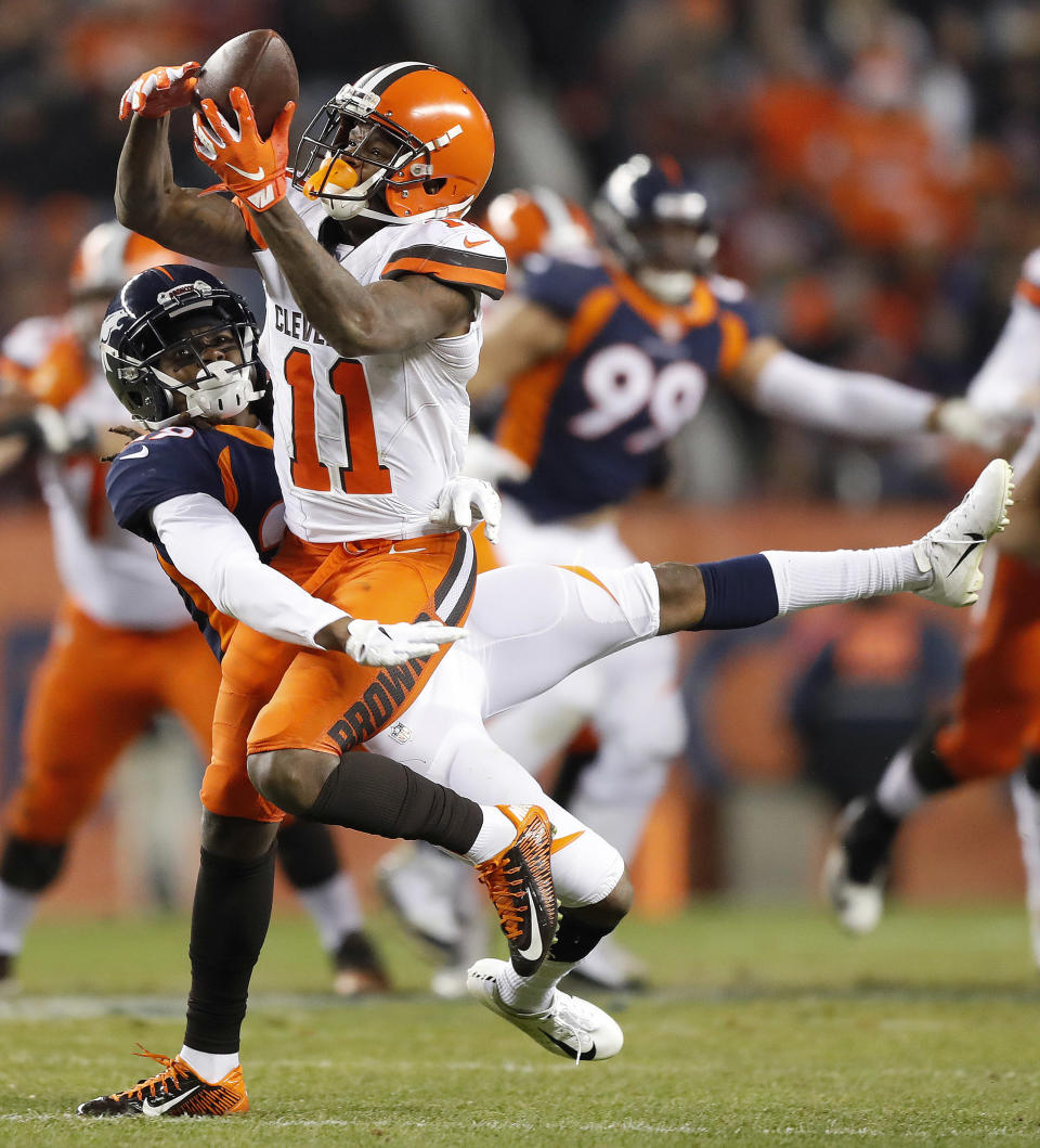 Cleveland Browns wide receiver Antonio Callaway (11) makes a catch as Denver Broncos cornerback Bradley Roby defends during the second half of an NFL football game, Saturday, Dec. 15, 2018, in Denver. (AP Photo/Jack Dempsey)