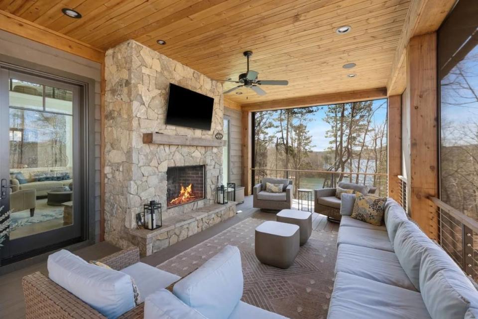 A screened-in patio area with a fireplace.