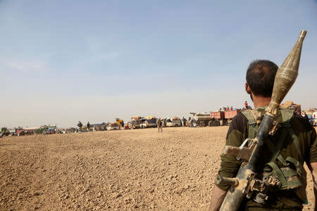 A member of Popular Mobilization Forces (PMF) fighter holds his weapon during a battle with Islamic State militants in west of Mosul, Iraq November 14, 2016. REUTERS/Stringer