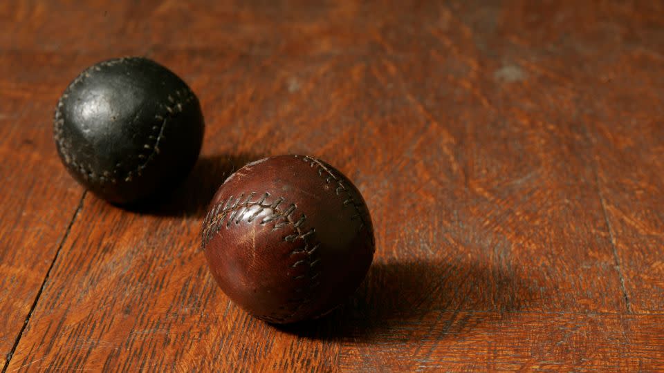 Two golf balls made from the leather of shoes worn by prisoners at Stalag Luft III, donated to the USGA Museum by Ward-Thomas. - Copyright John Mummert/USGA