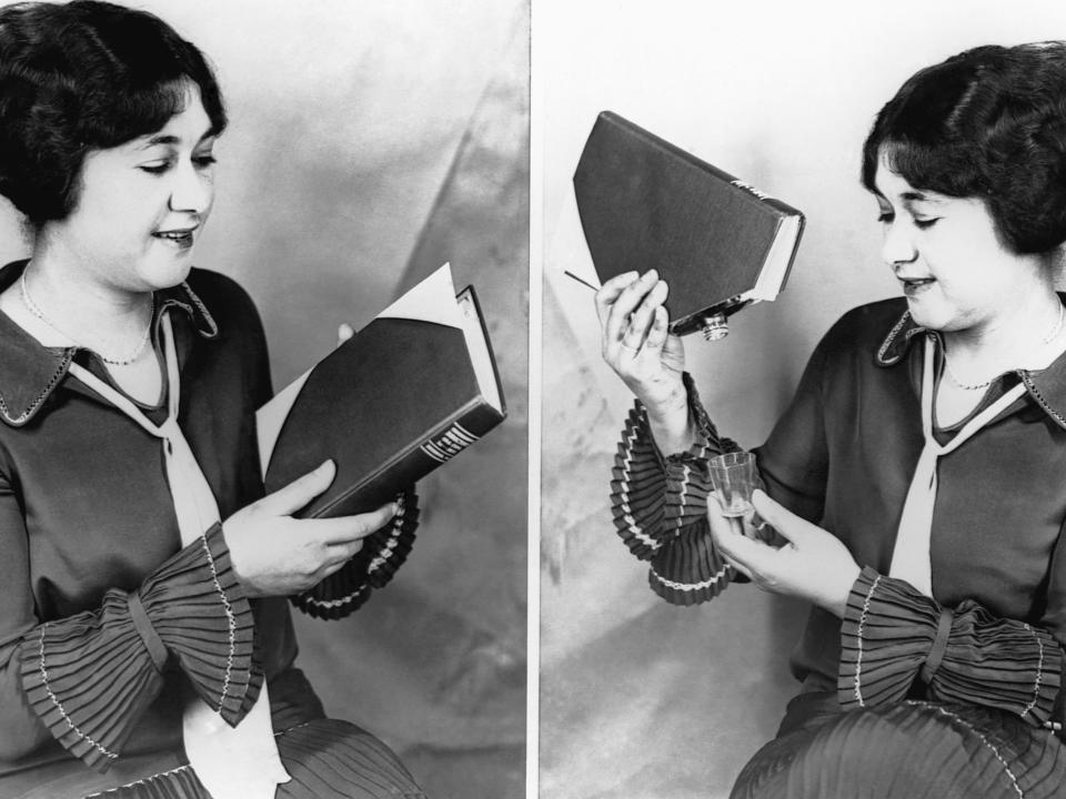 A woman with a Prohibition era book that hides a liquor flask.