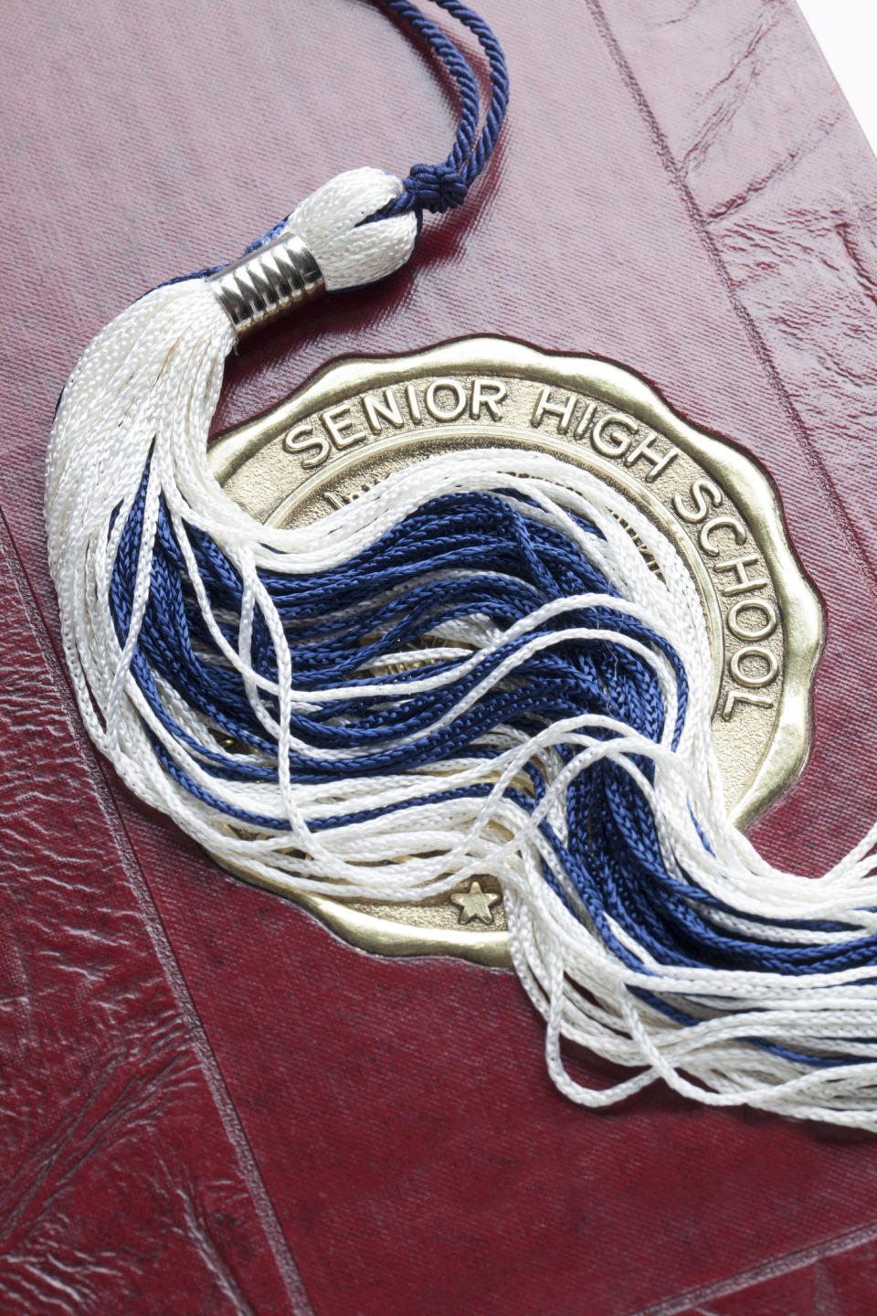 Graduation tassel on a high school yearbook