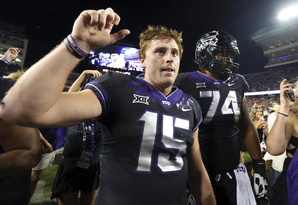 =TCU quarterback Max Duggan (15) raises his hand to make the horned frog gesture as the alma mater is played after the win over Kansas Statean NCAA college football game Saturday, Oct. 22, 2022, in Fort Worth, Texas. (AP Photo/Richard W. Rodriguez)