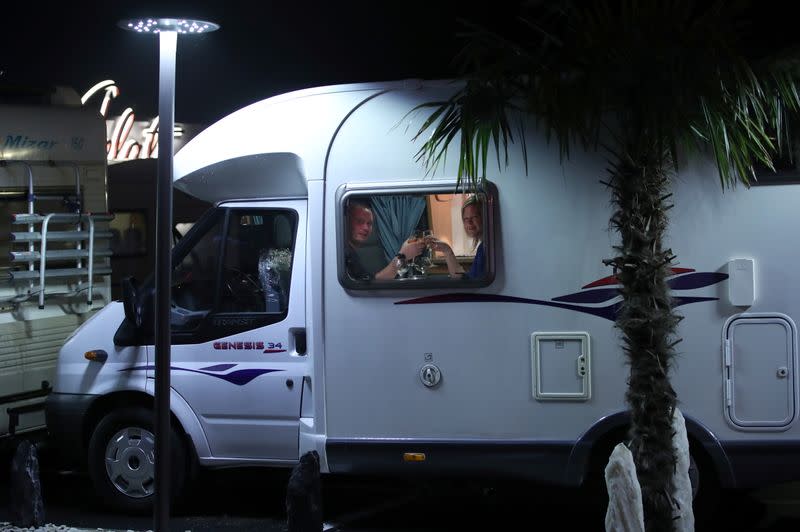 Customers enjoy dinner sitting inside a motorhome camper parked at the Belgian restaurant Matthias And Sea, despite the COVID-19 pandemic lockdown in Tarcienne