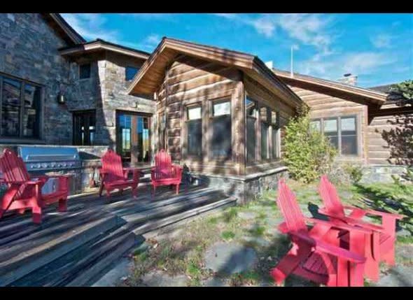 Red adirondack chairs bring color to one of the many outdoor terraces on the property.