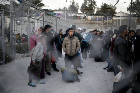 Refugees and migrants wait to be registered at the Moria refugee camp on the Greek island of Lesbos, November 5, 2015. REUTERS/Alkis Konstantinidis/File Photo