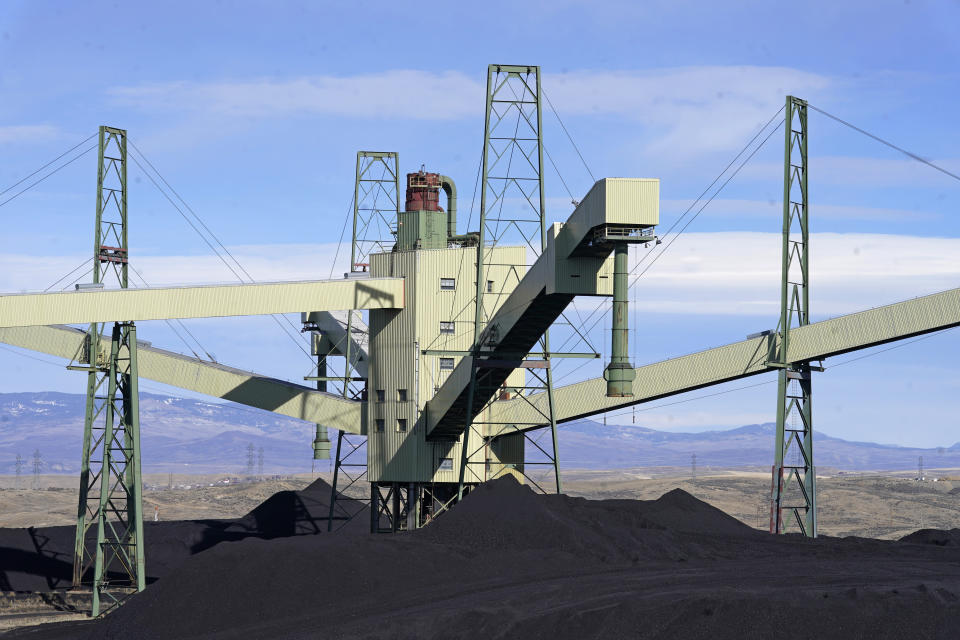 Coal sits at Craig Station, the power plant in Craig, Colo., Thursday, Nov. 18, 2021. The town in northwest Colorado is losing its coal plant, and residents fear it is the beginning of the end for their community. (AP Photo/Rick Bowmer)