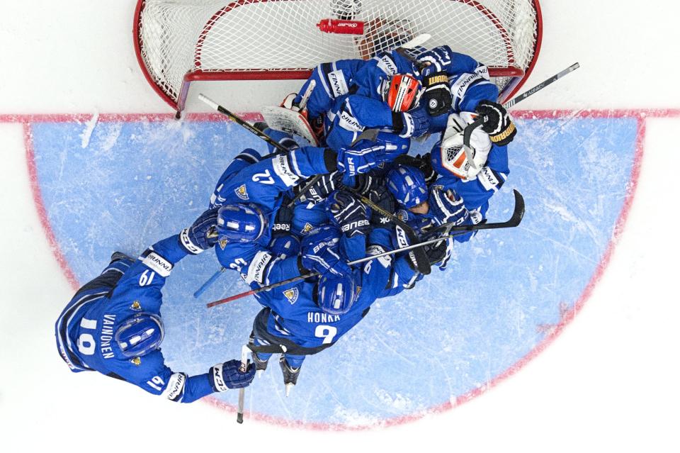 Finnish players land in a heap on top of goalie Juuse Saros after their 5-3 victory in the World Junior Hockey Championships quarter final between Finland and Czech Republic, at the Malmo Arena in Malmo, Sweden on Thursday, Jan. 2, 2014. (AP Photo /TT News Agency, Ludvig Thunman) SWEDEN OUT