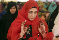 <p>A Pakistan girl offers prayers on the first day of Eid al-Adha, or Feast of Sacrifice, in Lahore, Pakistan, Saturday, Sept. 2, 2017. (Photo: K.M. Chaudary/AP) </p>