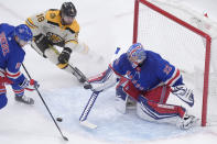 Boston Bruins center Pavel Zacha (18) is unable to score as New York Rangers goaltender Jonathan Quick (32) deflects the puck while defenseman Chad Ruhwedel (5) defends in the first period of an NHL hockey game, Thursday, March 21, 2024, in Boston. (AP Photo/Steven Senne)