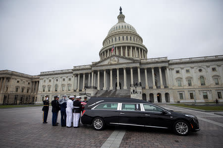 Joint service members of a military casket team carry the casket of Senator John McCain from the U.S. Capitol to a motorcade that will ferry him to a funeral service at the National Cathedral in Washington, U.S., September 1 2018. Jim Lo Scalzo/Pool via REUTERS