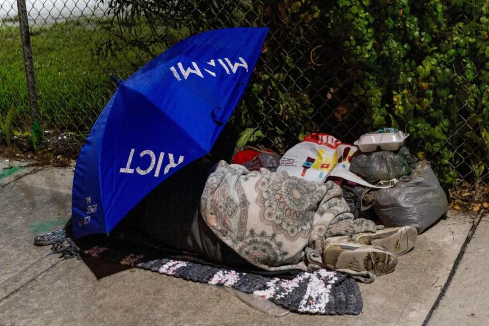 An unsheltered person sleeps on the sidewalk off NW 18th Street in Miami, Florida, on Friday, December 22, 2023. D.A. Varela/dvarela@miamiherald.com