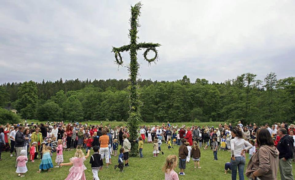 Swedish people celebrate Midsommar by dancing around a maypole. (AFP via Getty Images)