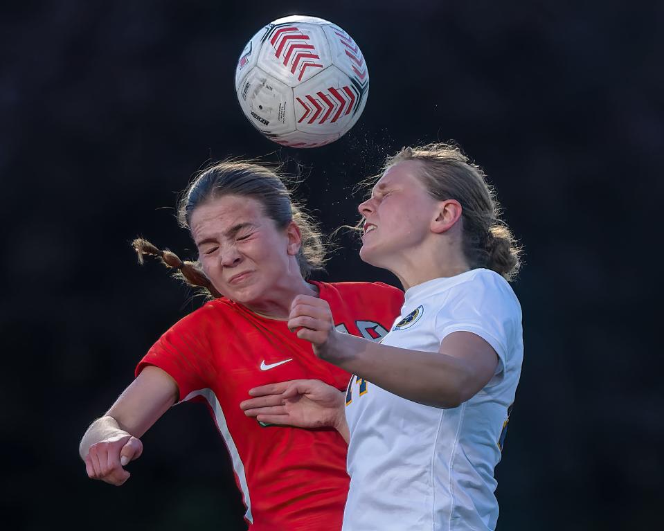 Canton's Taylor Steinagel (left) and Hartland's Addie Frantti battle a ball in the air during a 0-0 tie Thursday, May 2, 2024.