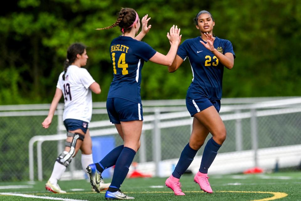 Haslett's Kama Amachree, right, celebrates her goal with teammate Ireland Jacob during the first half of the game against Mason on Tuesday, May 17, 2022, at Haslett High School. 