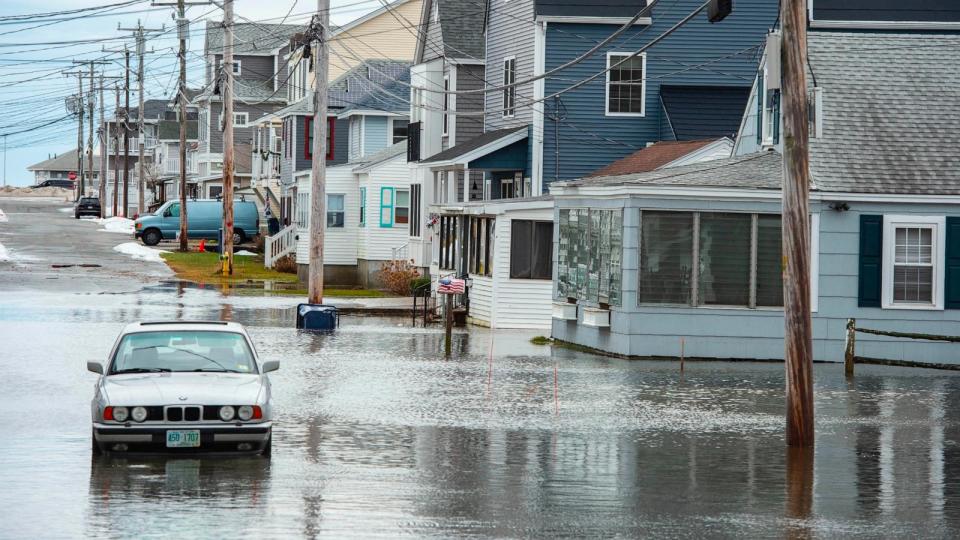 PHOTO: Homes and vehicles are surrounded by flood waters in Hampton, New Hampshire on January 10, 2024. (Joseph Prezioso/AFP via Getty Images)