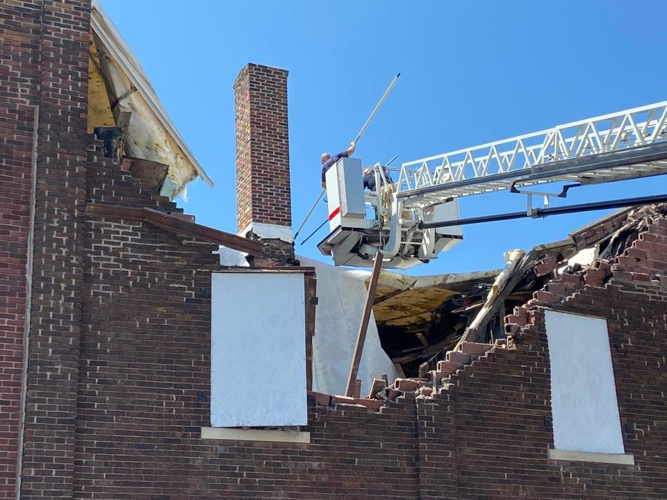 Richmond Fire Department personnel clears some loose material from a damaged building Saturday, July 2, 2022.