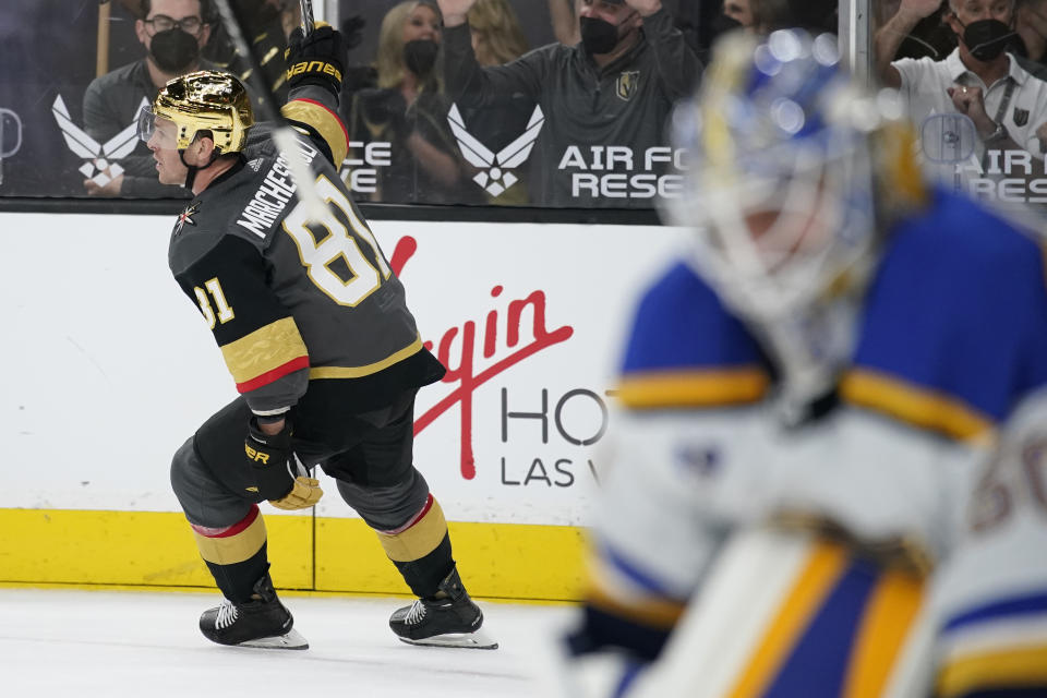 Vegas Golden Knights center Jonathan Marchessault (81) celebrates after scoring the game-winning goal against St. Louis Blues goaltender Jordan Binnington, right, during overtime of an NHL hockey game Friday, May 7, 2021, in Las Vegas. (AP Photo/John Locher)