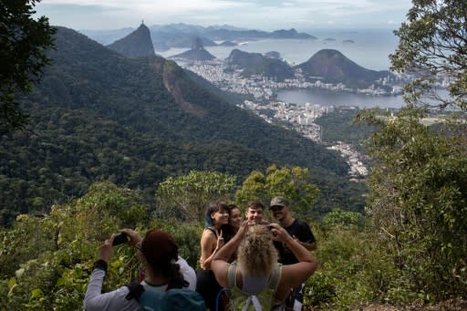 People take photos as they walk along a hiking trail above Rio de Janeiro -- part of a projected 8,000-kilometer trail across Brazil