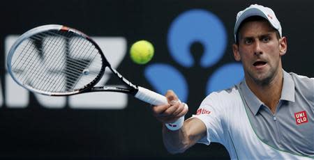 Novak Djokovic of Serbia hits a return to Leonardo Mayer of Argentina during their men's singles match at the Australian Open 2014 tennis tournament in Melbourne January 15, 2014. REUTERS/Jason Reed