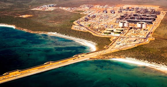 Overhead shot of operational energy facility in an arid climate along a coastline.