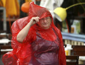 A South Beach tourist from Hungary braves the bad weather as she strolls down the empty sidewalks of Ocean Drive as a tropical storm warning was issued for coastal Miami-Dade, Fla., Monday, Sept. 3, 2018. Tropical Storm Gordon lashed South Florida with heavy rains and high winds on Monday, forcing holiday beachgoers to drier ground. (Carl Juste/Miami Herald via AP)