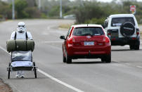 PERTH, AUSTRALIA - JULY 15: Stormtrooper Paul French is pictured on day 5 of his over 4,000 kilometre journey from Perth to Sydney walking down Old Mandurah Road on July 15, 2011 in Perth, Australia. French aims to walk 35-40 kilometres a day, 5 days a week, in full Stormtrooper costume until he reaches Sydney. French is walking to raise money for the Starlight Foundation - an organisation that aims to brighten the lives of ill and hostpitalised children in Australia. (Photo by Paul Kane/Getty Images)