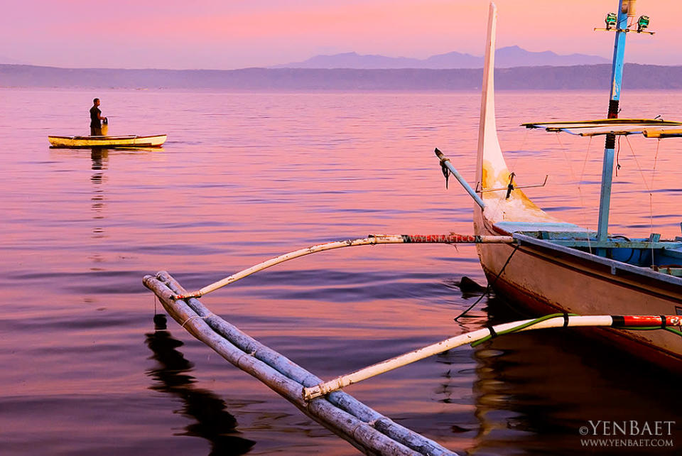 The sun sets on fishermen on Taal Lake. The lake is known for the maliputo and tawilis harvested from its waters. (Yen Baet)