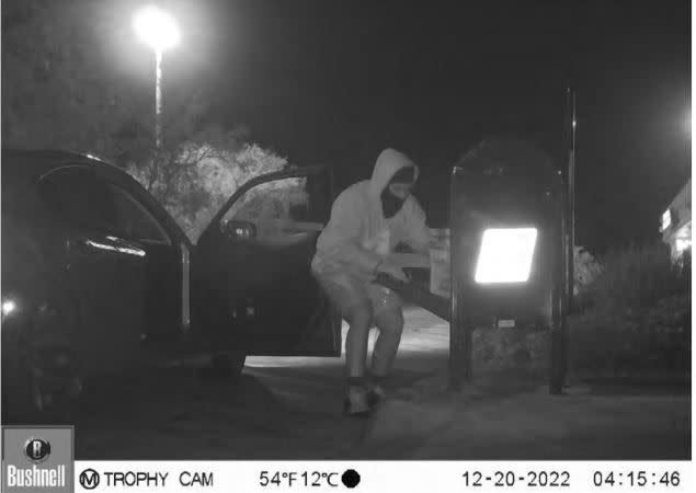 On December 20, 2022, a surveillance camera at the Friendship Center captured a male subject wearing a light-colored hooded sweater and  black ski mask opening the collection box with a key and removing
the plastic postal bin containing mail.