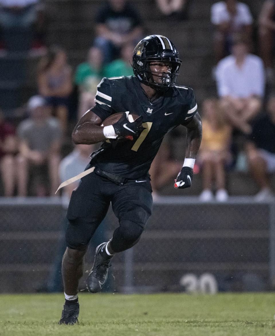 Raymond Cottrell (1) carries the ball during the Pensacola Catholic vs Milton football game at Milton High School on Thursday, Sept. 1, 2022.