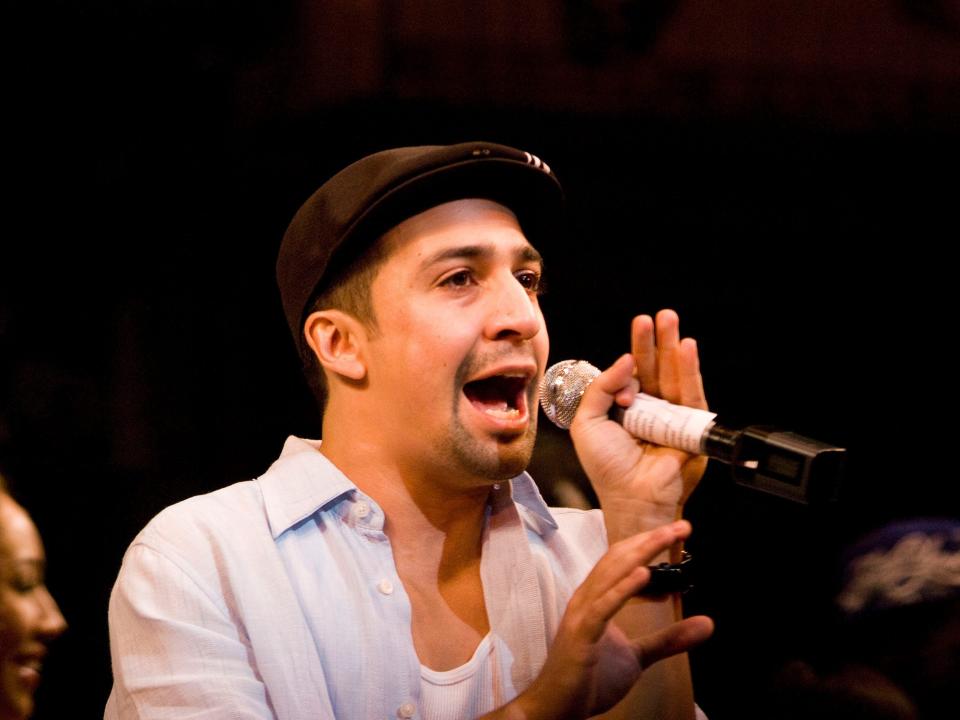 A closeup of Lin-Manuel Miranda singing in character.