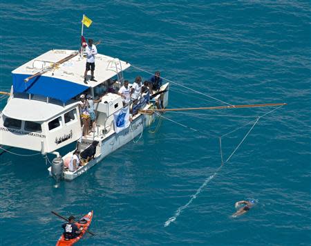 Diana Nyad, positioned about than two miles off Key West, Florida, swims towards the completion of her 111-mile trek from Cuba to the Florida Keys