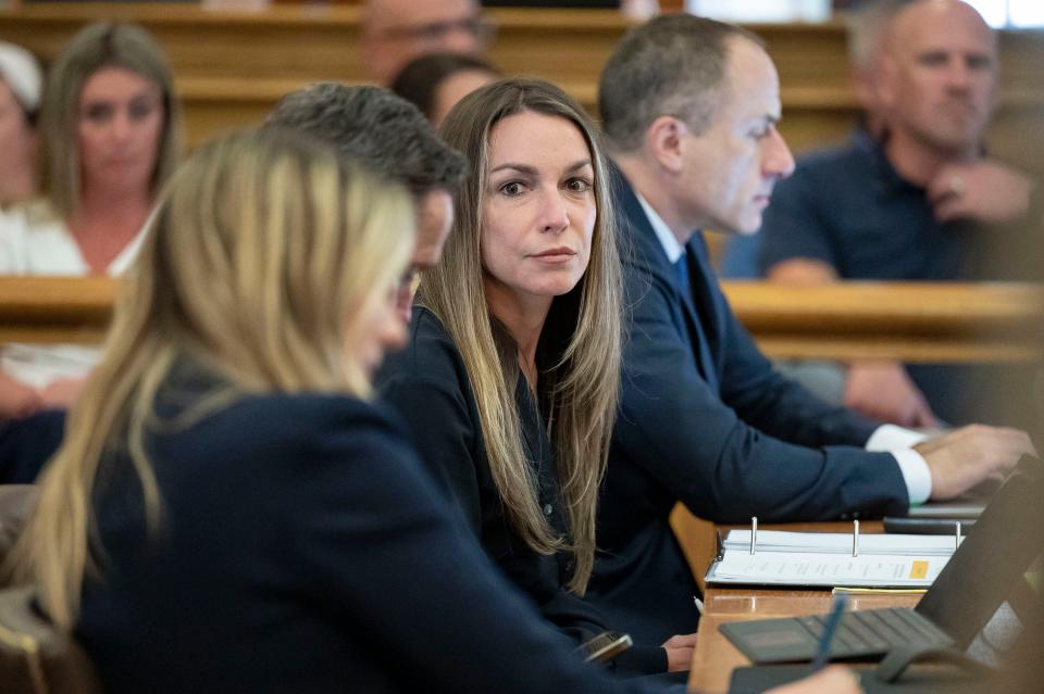 Karen Read, center, sits in court with her legal team during her trial at Norfolk County Superior Court, Thursday, June 20, 2024, in Dedham, Mass. Read is accused of backing her SUV into her Boston Police officer boyfriend, John O'Keefe, and leaving him to die in a blizzard in Canton, in 2022. (David McGlynn/The Patriot Ledger via AP, Pool)