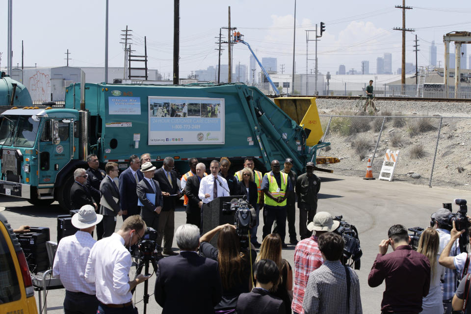 Los Angeles Mayor Eric Garcetti, at podium, surrounded by city officials and LA Sanitation and Environment employees, addresses the city's homelessness problem at a news conference in Los Angeles Wednesday, June 19, 2019. The two-term Democrat who not long ago flirted with a presidential run has been besieged by complaints about homeless encampments that have gotten so widespread he's facing a potential recall campaign. The low-key mayor who in 2016 helped convince voters to borrow $1.2 billion to construct housing for the homeless has found himself forced to explain why the problems have only gotten worse. (AP Photo/Damian Dovarganes)