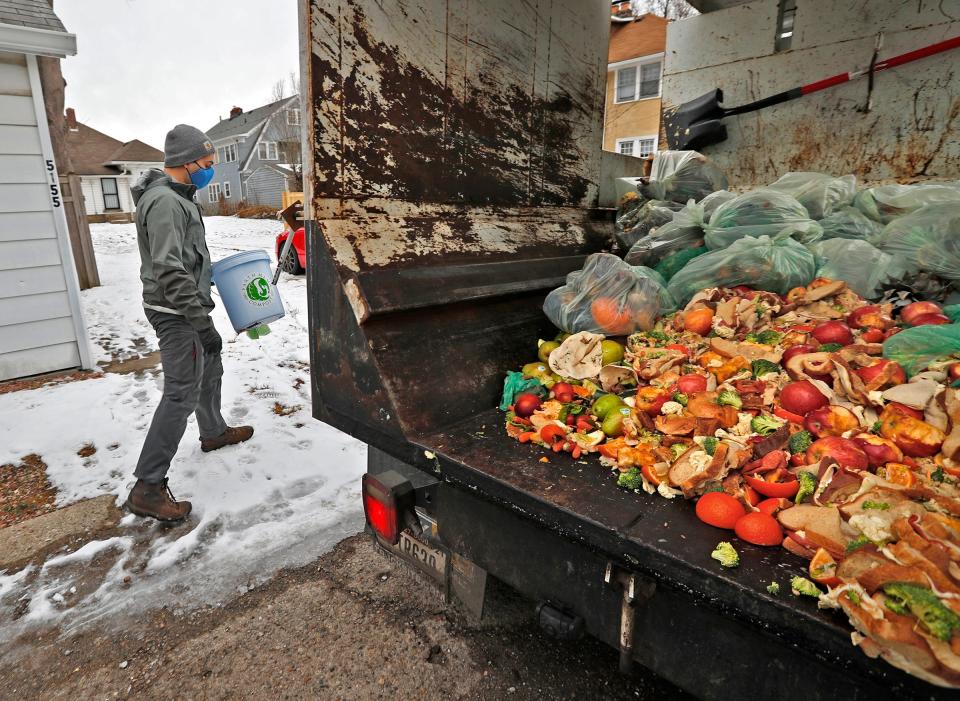 Nick Cooper-Garcia makes rounds collecting discarded food for Earth Mama Compost on Thursday, Feb. 4, 2021 in Indianapolis. The food will be used to make compost.