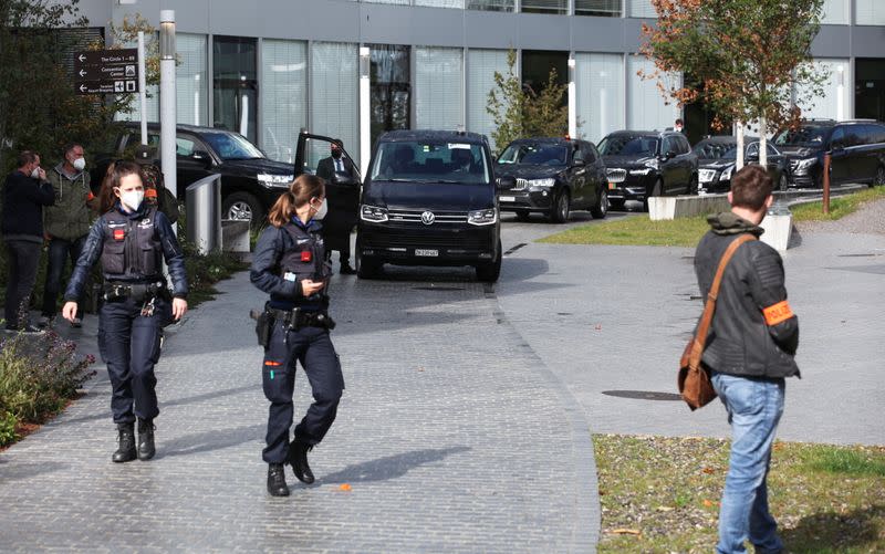 Swiss police officers and a limousine convoy are seen in front of the Hyatt Regency Zurich Airport hotel in Zurich