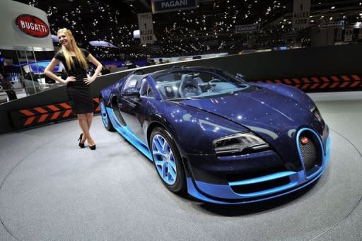 A Bugatti Veyron Grand Sport Vitesse is displayed at the car maker's booth ahead of the Geneva Motor Show. Sports cars, reputed for being energy guzzlers, are now trying to boost their green credentials as they seek to attract environmentally conscious consumers and meet new climate standards