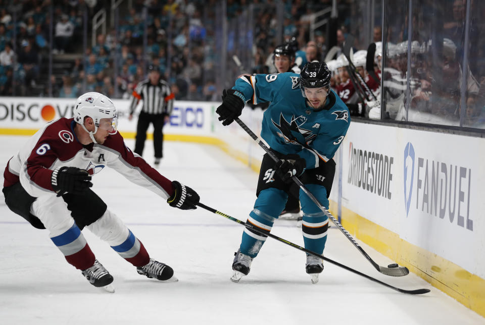 Colorado Avalanche's Erik Johnson (6) battles for the puck against San Jose Sharks' Logan Couture (39) in the first period of Game 1 of an NHL hockey second-round playoff series at the SAP Center in San Jose, Calif., on Friday, April 26, 2019. (AP Photo/Josie Lepe)