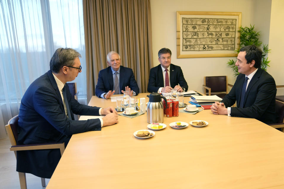 Serbian President Aleksandar Vucic, left, and Kosovo's Prime Minister Albin Kurti, right, meet with European Union foreign policy chief Josep Borrell, second left, in Brussels, Monday, Feb. 27, 2023. The leaders of Serbia and Kosovo are holding talks Monday on European Union proposals aimed at ending a long series of political crises and setting the two on the path to better relations and ultimately mutual recognition. (AP Photo/Virginia Mayo)