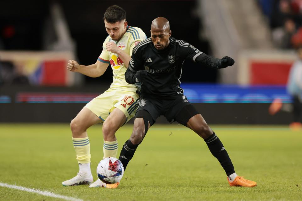 Mar 4, 2023; Harrison, New Jersey, USA; New York Red Bulls midfielder Lewis Morgan (10) and Nashville SC midfielder Fafa Picault (7) battle for the ball during the first half at Red Bull Arena.