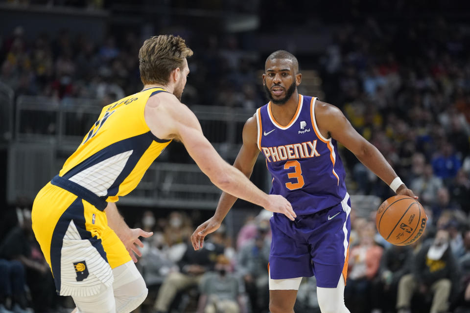 Phoenix Suns' Chris Paul (3) is defended by Indiana Pacers' Domantas Sabonis (11) during the second half of an NBA basketball game, Friday, Jan. 14, 2022, in Indianapolis. (AP Photo/Darron Cummings)