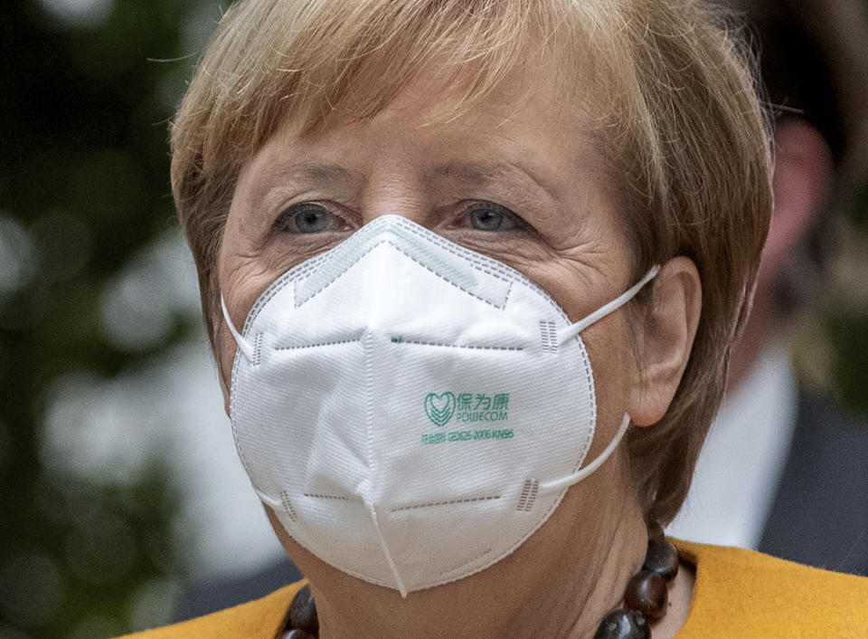 German Chancellor Angela Merkel arrives for a press conference in Berlin, Germany, Monday, Nov. 2, 2020. (AP Photo/Michael Sohn)