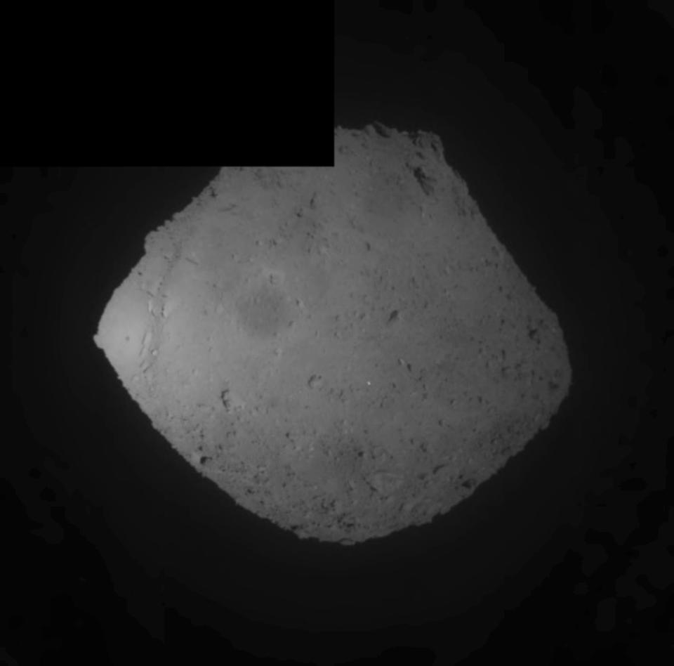 This image released by the Japan Aerospace Exploration Agency (JAXA) shows the asteroid Ryugu Friday, April 5, 2019. Japan's space agency JAXA said its Hayabusa2 spacecraft released an explosive onto the asteroid to make a crater on its surface and collect underground samples to find possible clues to the origin of the solar system. Friday's mission is the riskiest for Hayabusa2, as it has to immediately get away so it won't get hit by flying shards from the blast. (JAXA via AP)