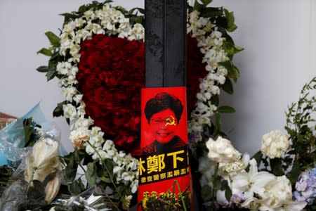 A poster showing Hong Kong leader Carrie Lam and the message "Step down" is seen at a memorial for a protester who fell to his death, at the Legislative Council a day after protesters broke into the building in Hong Kong