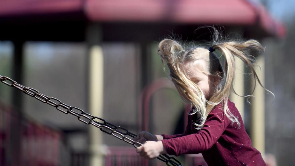 Hazel Ruckman, 4, of North Canton flies her ponytails in the air on a warm, sunny afternoon last week at Price Park in North Canton.