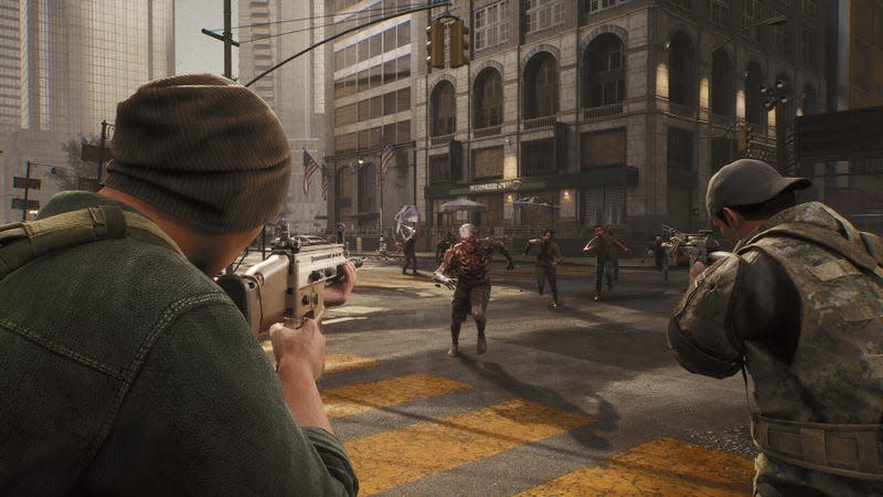 Zombies run at people holding guns in a city intersection. 